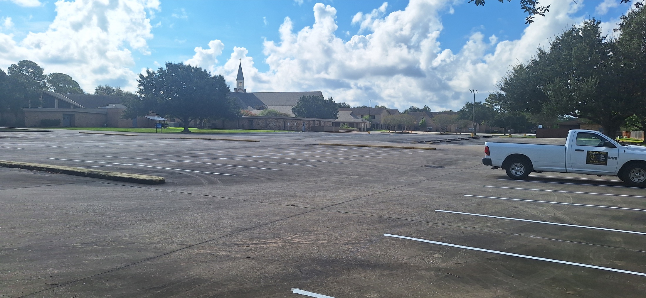 Wide view of freshly striped white parking lines at Sugar Land Methodist Church
