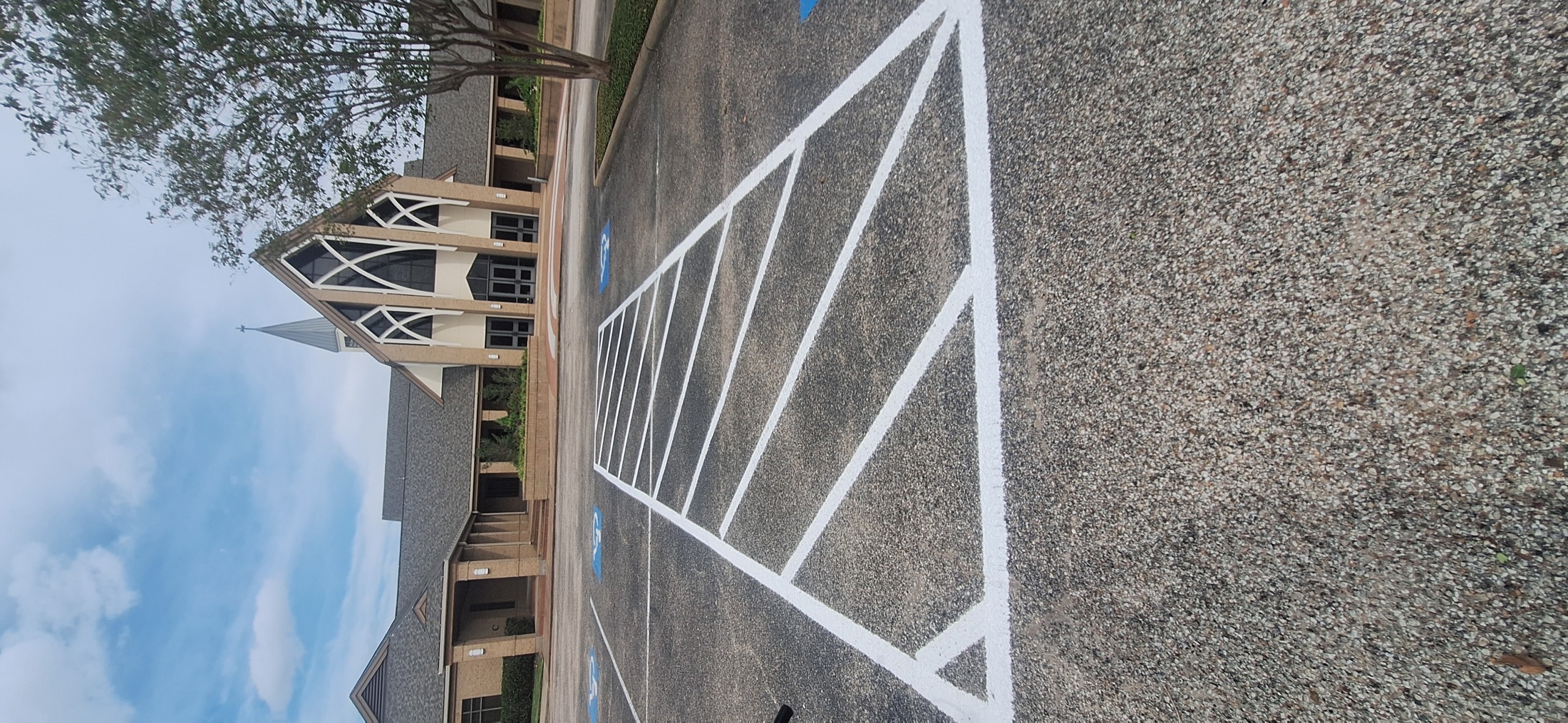 Fresh white parking and access-aisle lines in front of Sugar Land Methodist Church