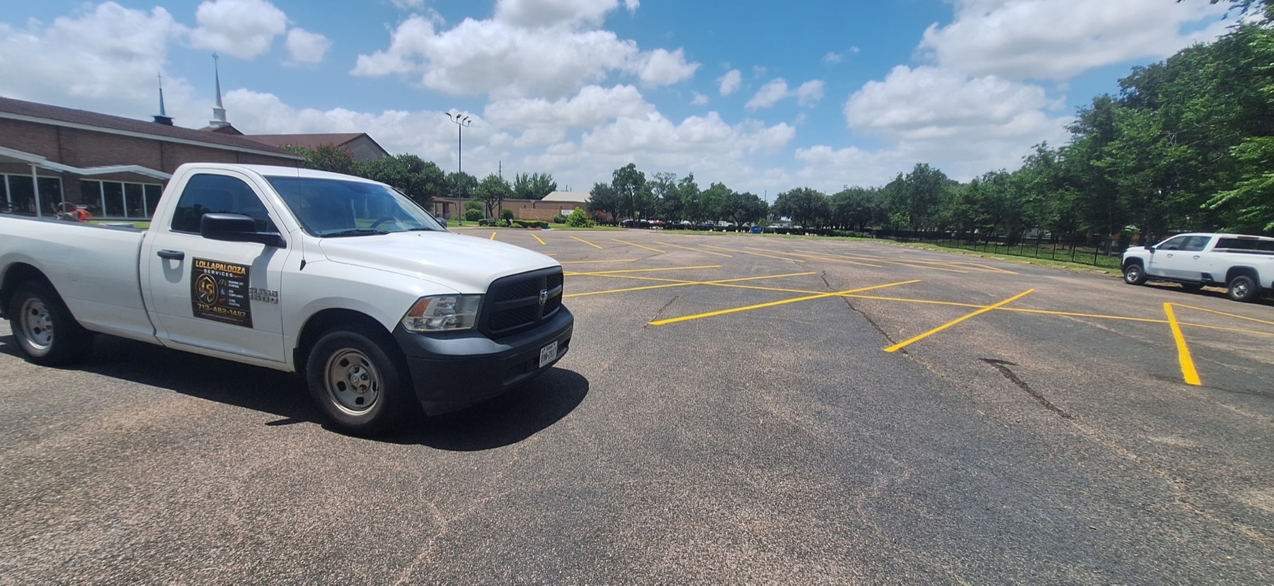 Lollalpalooza Services work truck at a completed parking lot striping project